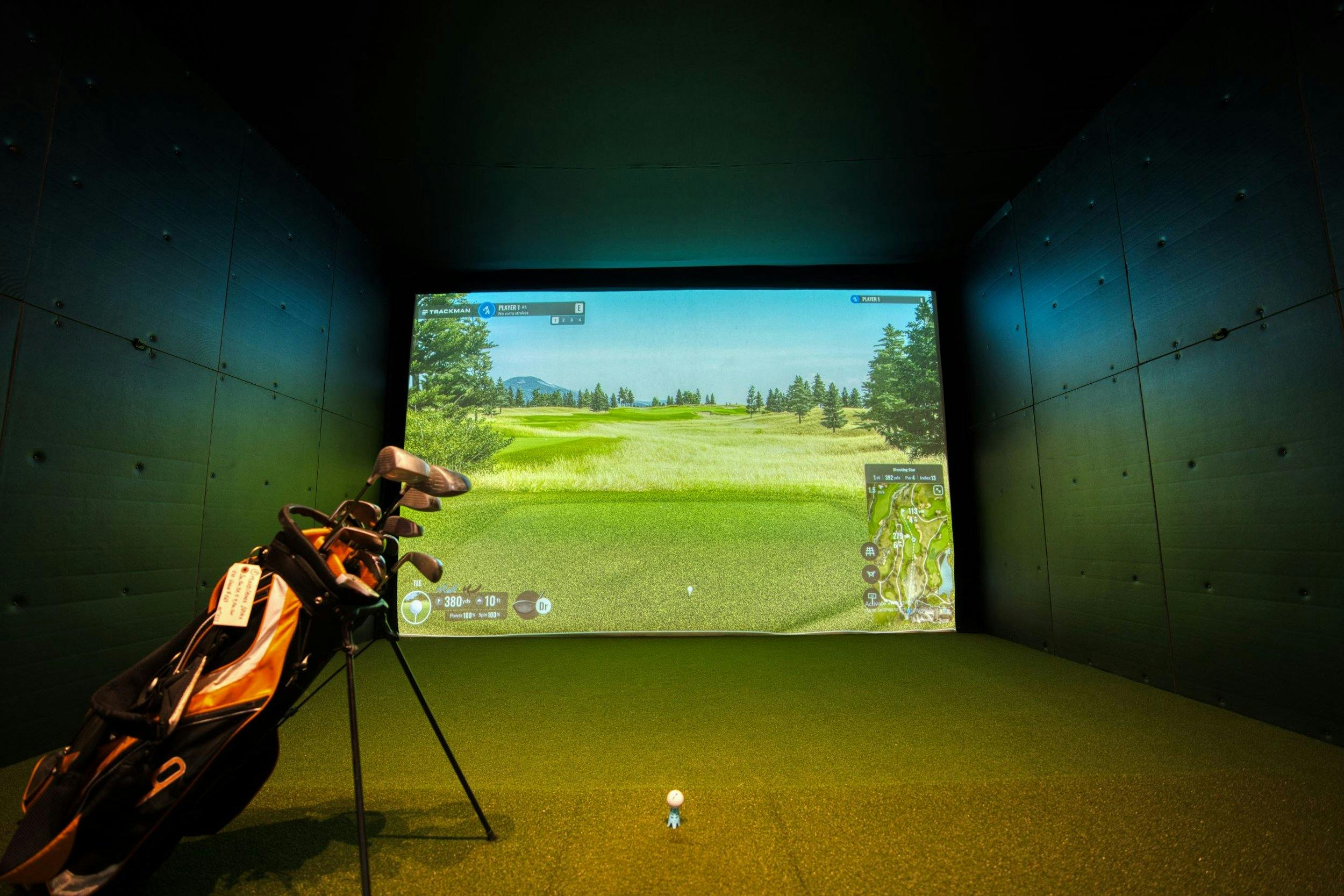 Golf simulator lounge at Santé Apartments Kingston — play any course from your building